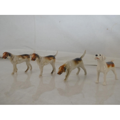 117 - A Beswick Hound dog (a/f) and three others.