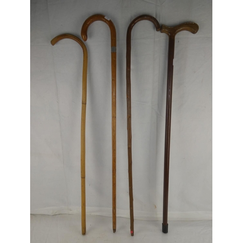 121 - Four vintage walking canes.