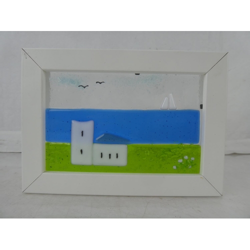 138 - A small framed studio glass panel of a church and boat, measuring 7