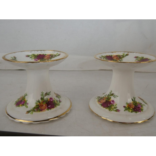 139 - A pair of Royal Albert Old Country Rose candlesticks and a brass candlesnuffer.