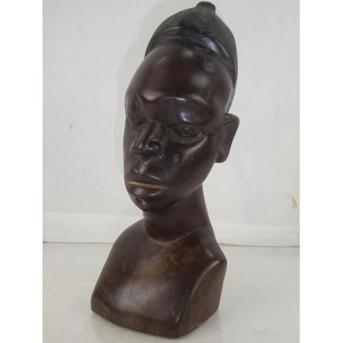 141 - A large wooden African carved bust, measuring 11