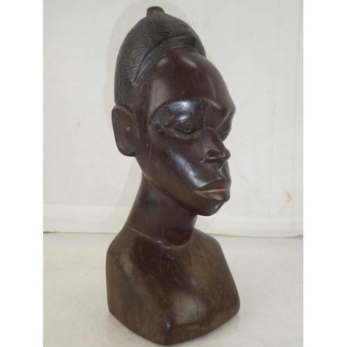 141 - A large wooden African carved bust, measuring 11