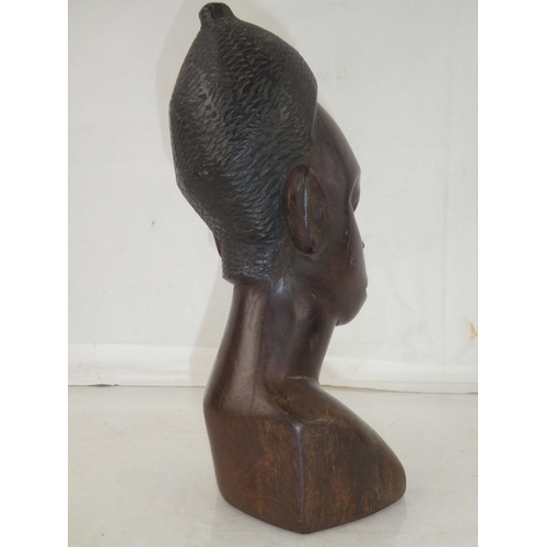 141 - A large wooden African carved bust, measuring 11