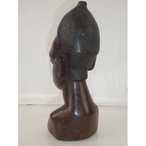 141 - A large wooden African carved bust, measuring 11