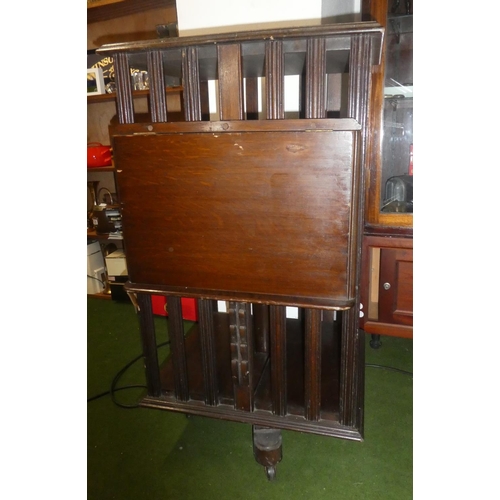 150 - An antique oak revolving bookcase with lift up book rest.