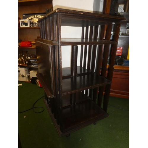 150 - An antique oak revolving bookcase with lift up book rest.