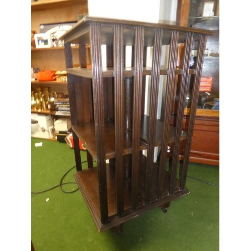 150 - An antique oak revolving bookcase with lift up book rest.