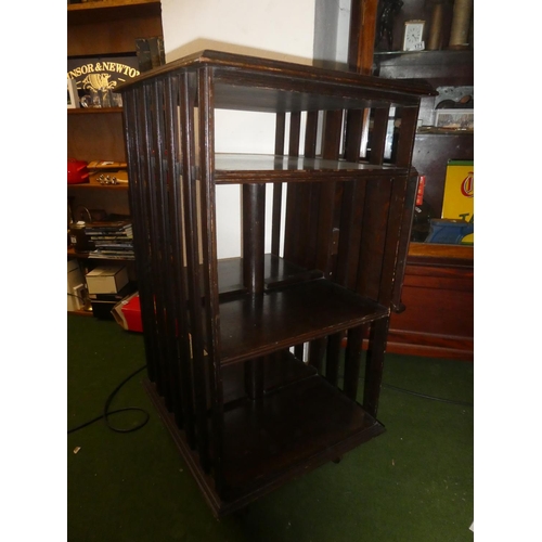 150 - An antique oak revolving bookcase with lift up book rest.