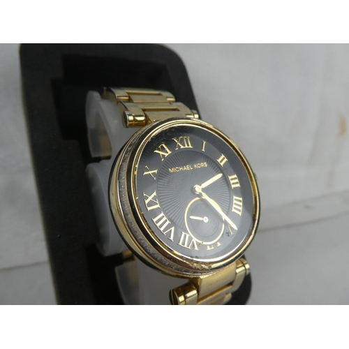 87 - A Michael Korrs wrist watch.