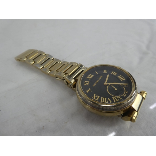 87 - A Michael Korrs wrist watch.