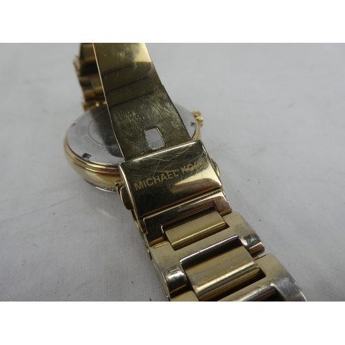 87 - A Michael Korrs wrist watch.