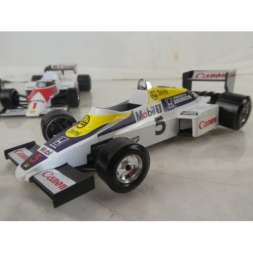 159 - A lot of five Burago Formula One toy racing cars to include McLarnen, Lotus and more.