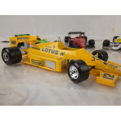 159 - A lot of five Burago Formula One toy racing cars to include McLarnen, Lotus and more.