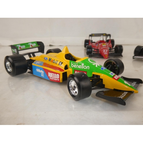 159 - A lot of five Burago Formula One toy racing cars to include McLarnen, Lotus and more.