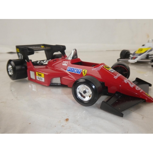 159 - A lot of five Burago Formula One toy racing cars to include McLarnen, Lotus and more.