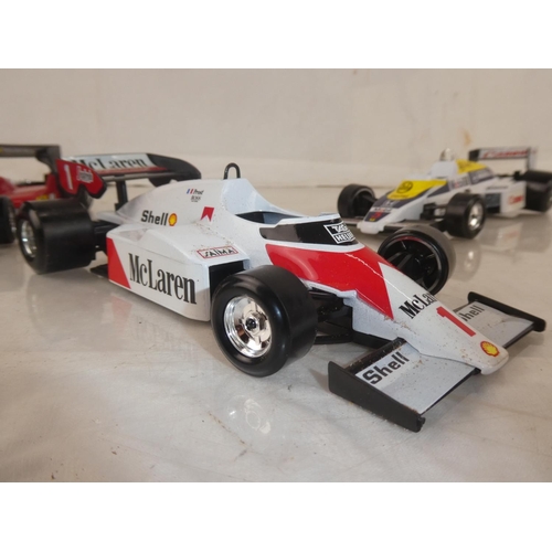 159 - A lot of five Burago Formula One toy racing cars to include McLarnen, Lotus and more.