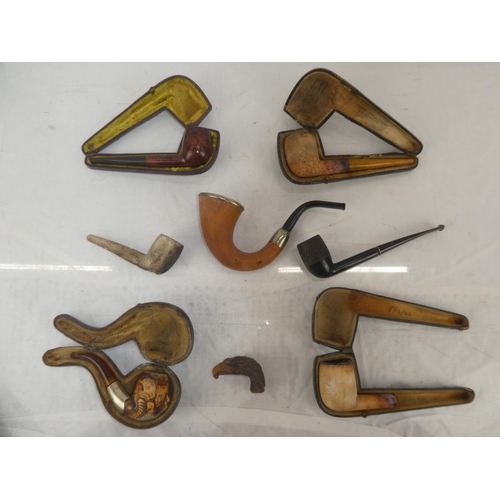 164 - A collection of antique pipes and their leather cases to include Brilon number 6 Swedish pipe.