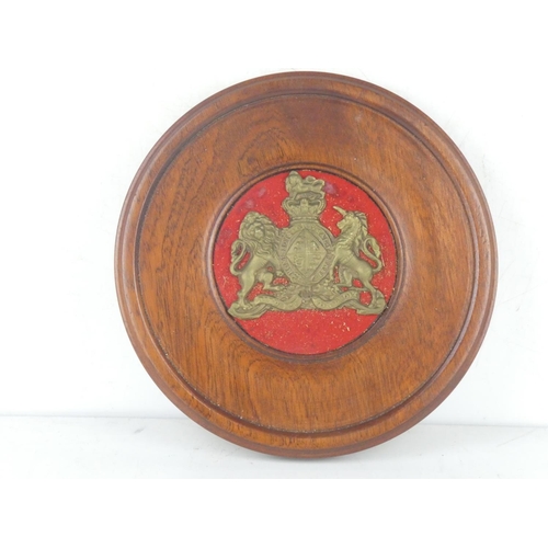 208 - A mahogany wall plaque with brass crest, measuring 9