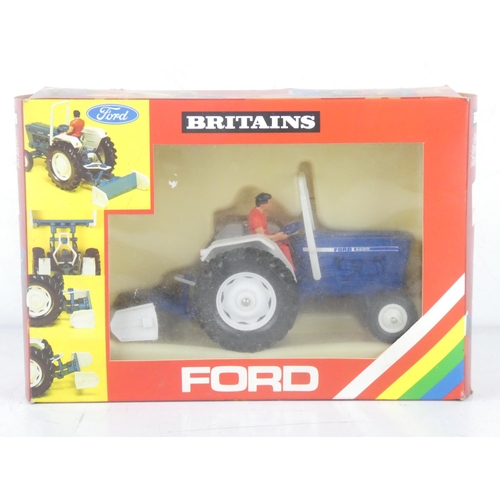 217 - A boxed Britains 9516 Ford Tractor and Yard Scraper.