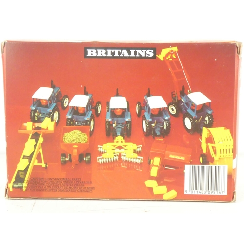 217 - A boxed Britains 9516 Ford Tractor and Yard Scraper.