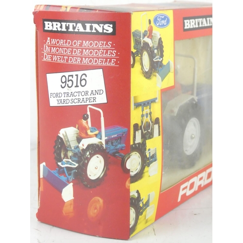 217 - A boxed Britains 9516 Ford Tractor and Yard Scraper.