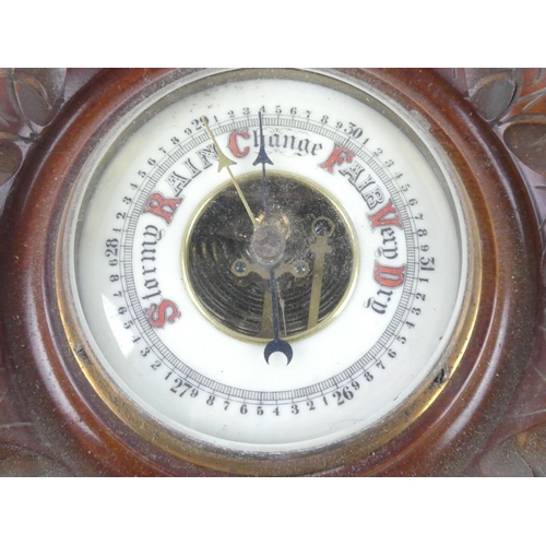 257 - An antique mahogany barometer with carved detail and porcelain dial, measuring 14