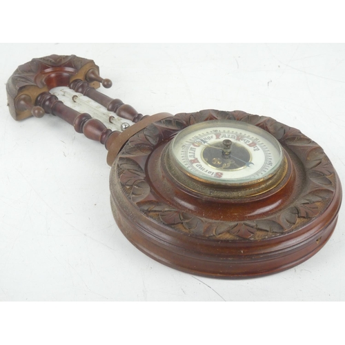 257 - An antique mahogany barometer with carved detail and porcelain dial, measuring 14