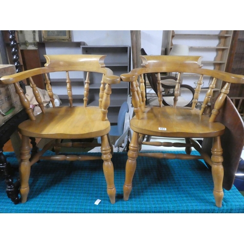 591 - A pair of pine captain style carver chairs.