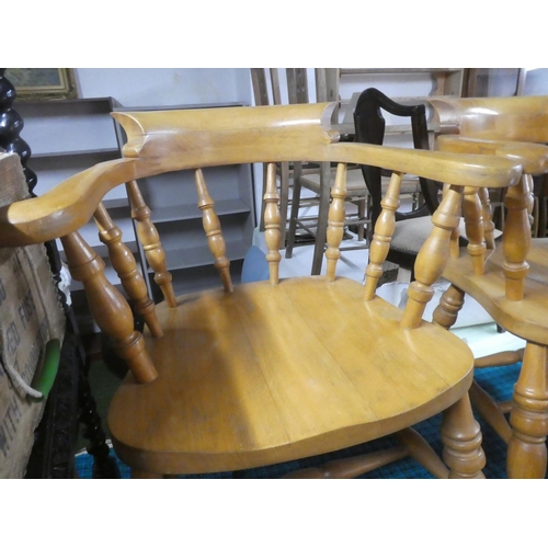 591 - A pair of pine captain style carver chairs.