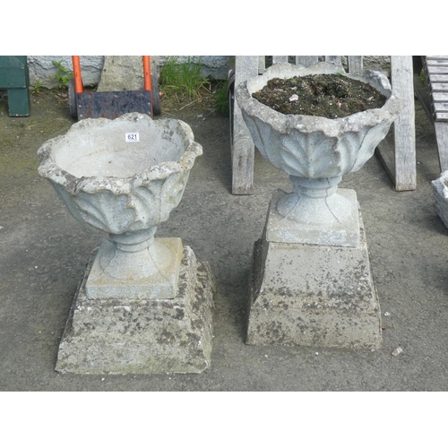 621 - Two similar concrete garden planters and plinths, measuring 27