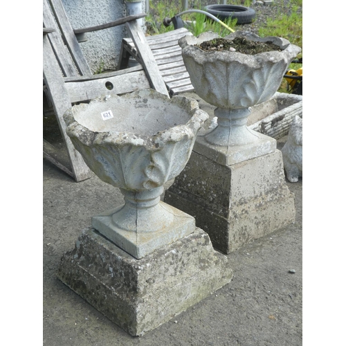 621 - Two similar concrete garden planters and plinths, measuring 27