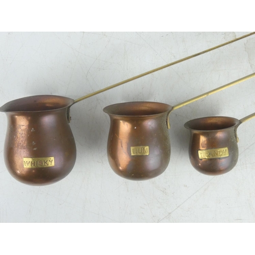 25 - A set of three vintage copper measures.