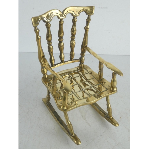 44 - A large vintage brass rocking chair.