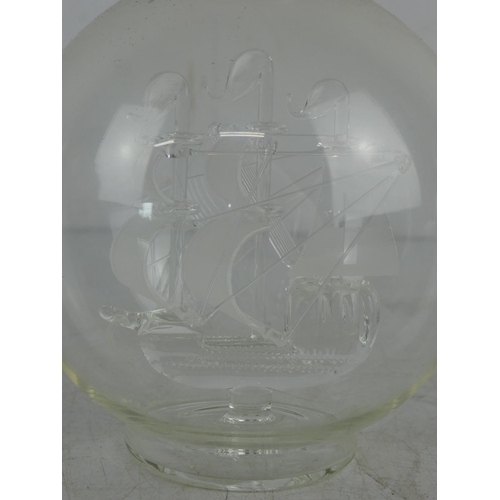 50 - A glass ship in a glass decanter.