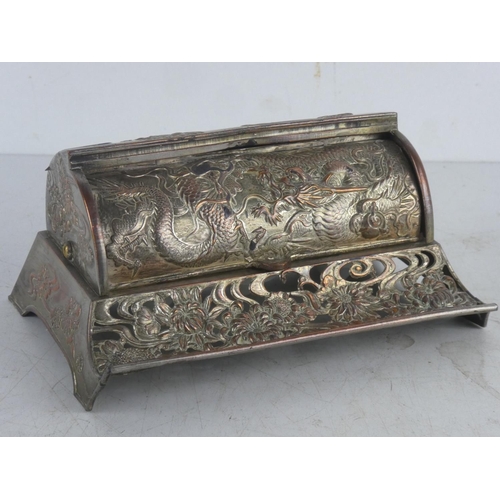 51 - A decorative metal Oriental style inkwell set, with roll top cover.