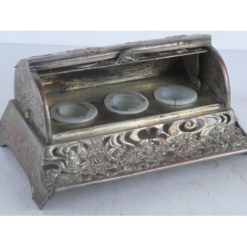 51 - A decorative metal Oriental style inkwell set, with roll top cover.