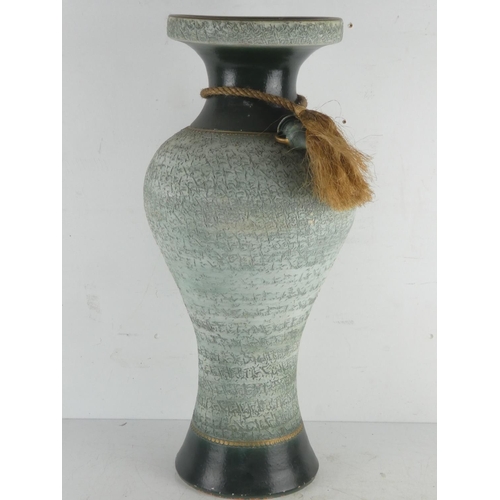 59 - A large green pottery vase with rope detail.