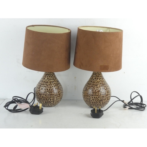 62 - A pair of ceramic table lamps and shades.