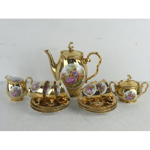 67 - A vintage gilt coffee set.