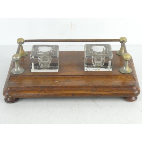 76 - An antique oak double inkwell desk set with gallery back.