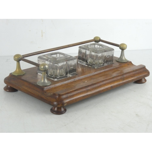 76 - An antique oak double inkwell desk set with gallery back.