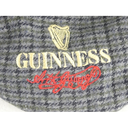 82 - A Guinness tartan cap.