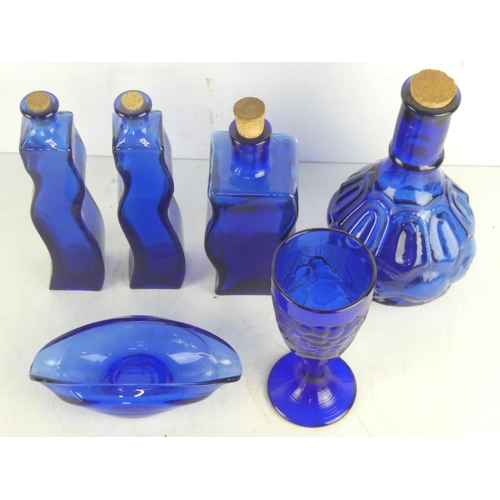 84 - A collection of blue glass ware.