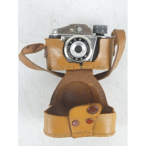 113 - A miniature Minetta camera in leather case.