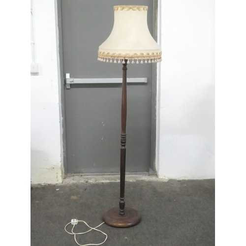 131 - A vintage oak standard lamp and shade.