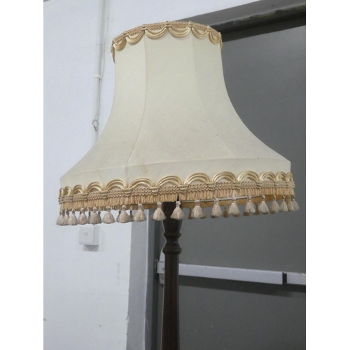 131 - A vintage oak standard lamp and shade.