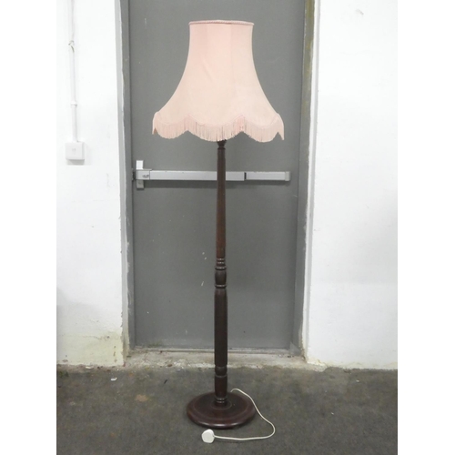 132 - A vintage mahogany standard lamp and shade.