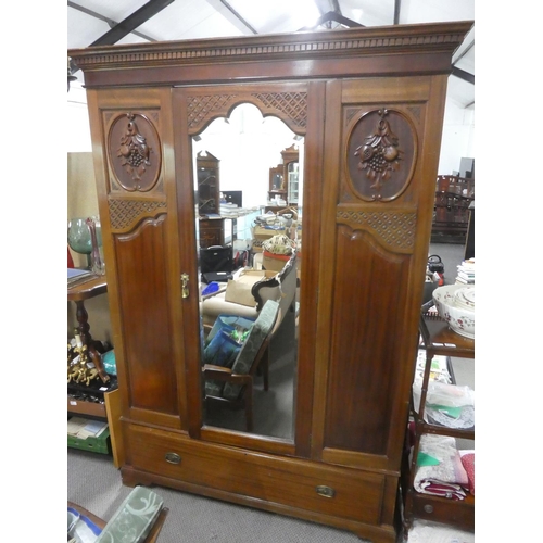 142 - A stunning antique mahogany wardrobe with carved panels and mirror.