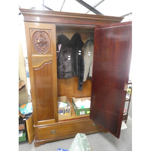 142 - A stunning antique mahogany wardrobe with carved panels and mirror.