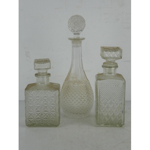 156 - Three vintage pressed glass decanters.